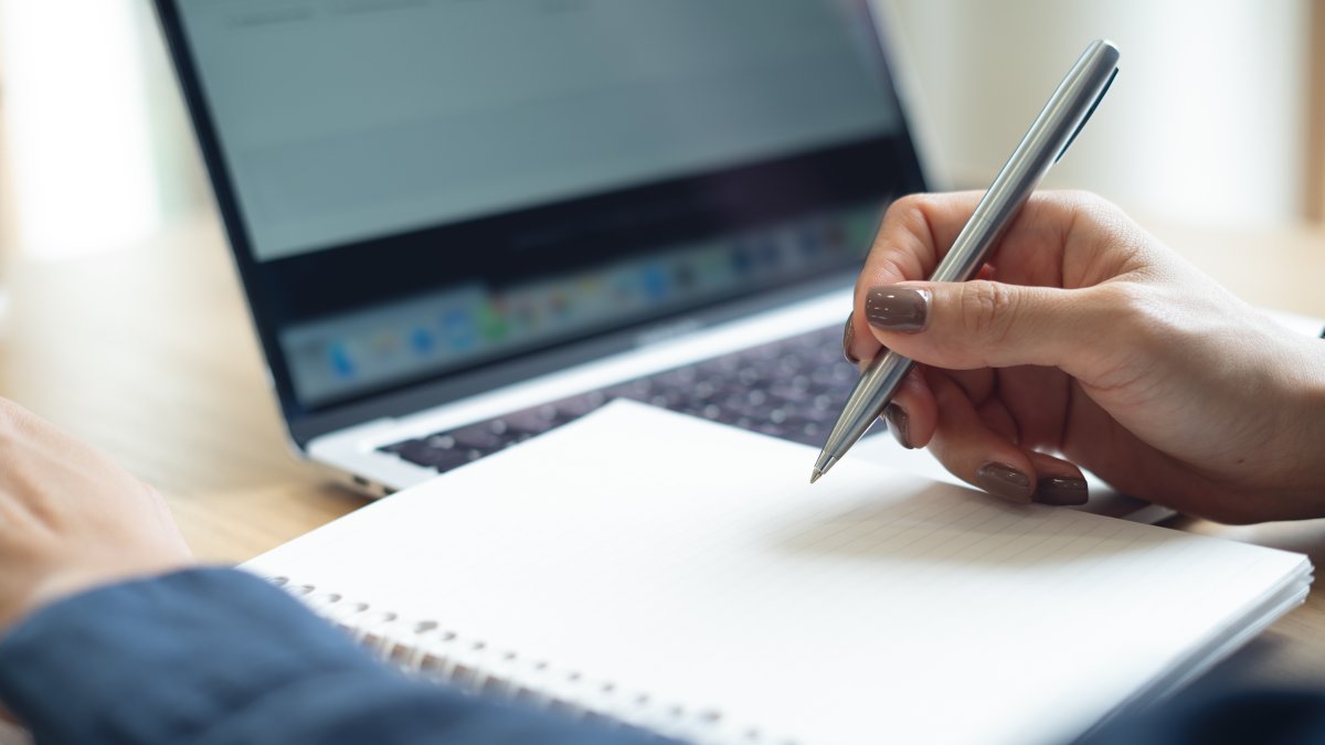 A woman studies on her laptop at home. (Shutterstock Photo)