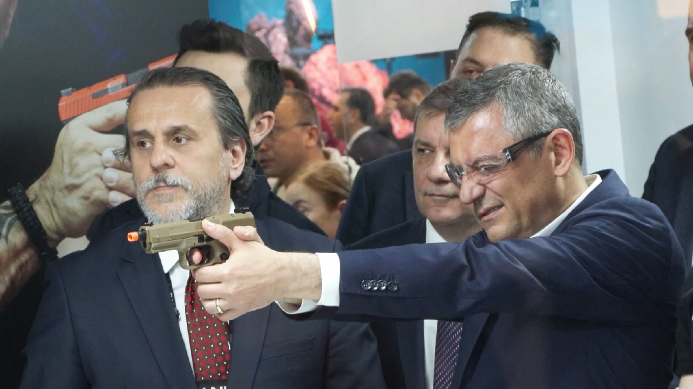 Özgür Özel, then CHP chairperson, tests a gun during a visit to a defense fair, Istanbul, Türkiye, May 7, 2026. (DHA Photo)