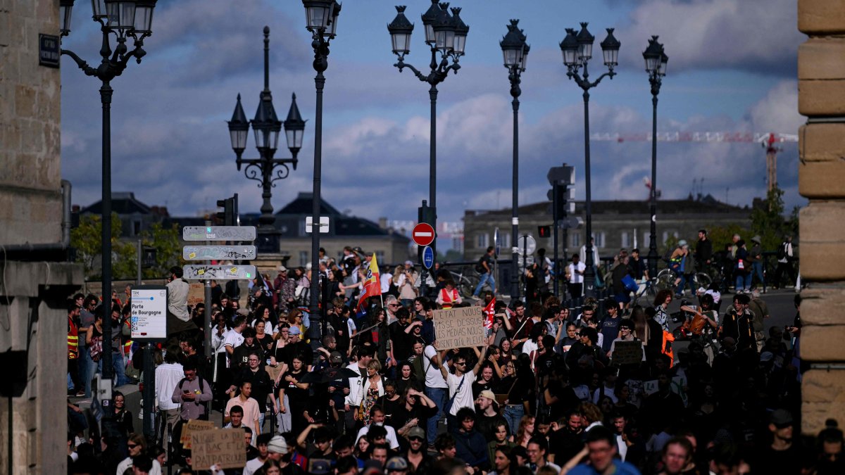 Protesters hold placards during a demonstration of high school students in Bordeaux, southwestern France, Oct. 13, 2026. (AFP Photo)