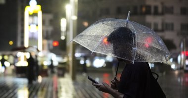 A man waits in the rain under an umbrella, Istanbul, Türkiye, Sept. 27, 2026. (AA Photo)