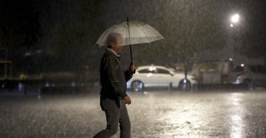 A man walks along a street as rainy and windy weather affects Istanbul, Türkiye, Sept. 27, 2026. (AA Photo)