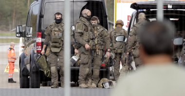 Members of a police special operations unit (SEK) are on the move within the Nuremberg airport grounds in Nuremberg, Germany, Oct. 13, 2026. (AP Photo)