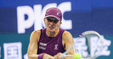 Poland's Iga Swiatek in action against Belgium's Elise Mertens during their Women’s Singles match at the China Open tennis tournament, Beijing, China, Oct. 9, 2026. (EPA Photo)