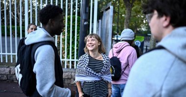 Swedish activist Greta Thunberg speaks with students as they prepare to take part in a blockade at the Lycee Paul Eluard in Saint-Denis, on the outskirts of Paris, Oct. 13, 2026. (AFP Photo)