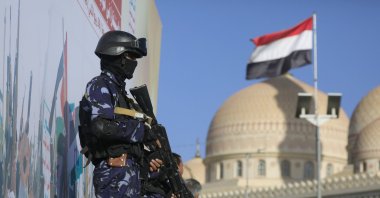 A Yemeni flag (R) flutters as Houthi soldiers stand guard during a protest against Saudi Arabia, in Sana'a, Yemen, Oct. 9, 2026. (EPA Photo)