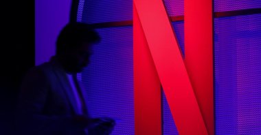 A man stands next to a Netflix logo during an event in Mumbai, India, Feb. 29, 2024. (Reuters Photo)
