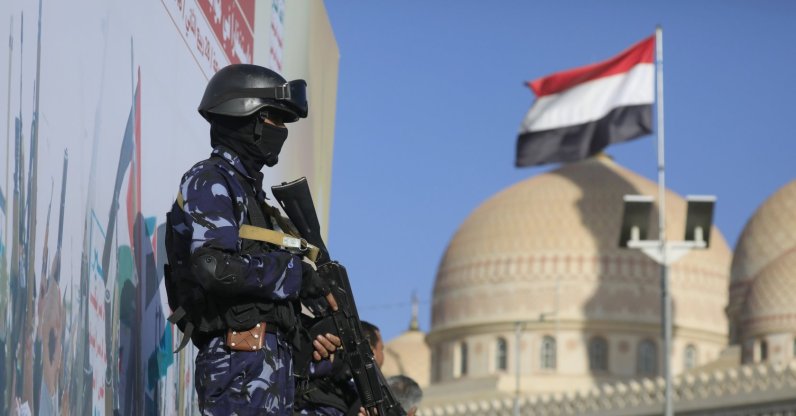 A Yemeni flag (R) flutters as Houthi soldiers stand guard during a protest against Saudi Arabia, in Sana'a, Yemen, Oct. 9, 2026. (EPA Photo)