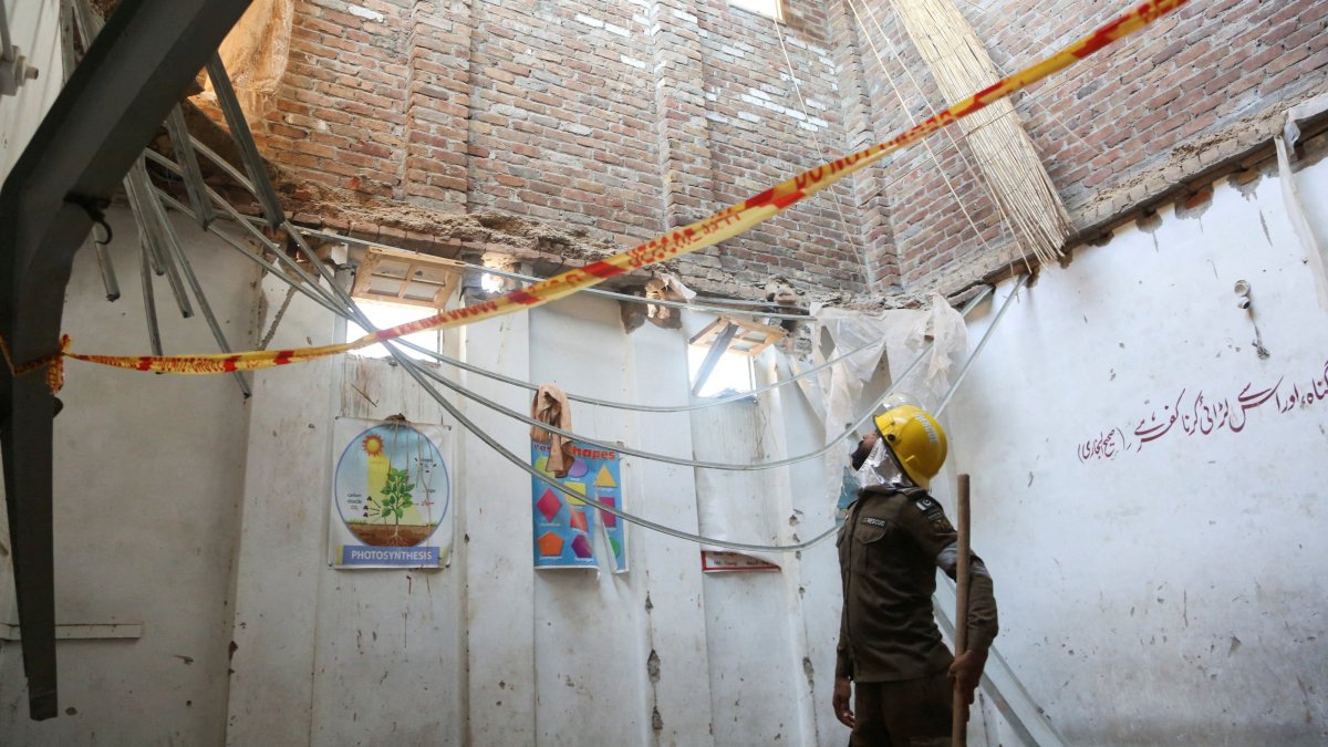 A rescue staff stands in a classroom after a school roof collapse in Peshawar, Pakistan, Oct. 15, 2026. (Reuters Photo)
