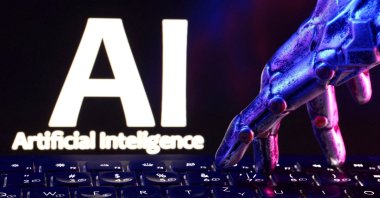 The words "AI Artificial Intelligence," a keyboard and a robotic hand are seen in this illustration created on Sept. 23, 2026. (Reuters Photo)