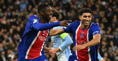 Paris Saint-Germain's Ousmane Dembele (L) celebrates with Achraf Hakimi after scoring their second goal in the UEFA Champions League league-phase match against Manchester City at the Etihad Stadium, Manchester, U.K., Oct. 14, 2026. (AFP Photo)