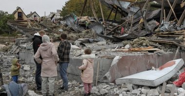 Residents stand at the site of a private house destroyed during a Russian airstrike on the outskirts of Dnipro, Ukraine, Oct. 15, 2026. (Reuters Photo)