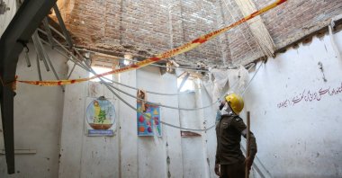 A rescue staff stands in a classroom after a school roof collapse in Peshawar, Pakistan, Oct. 15, 2026. (Reuters Photo)
