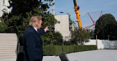 U.S. President Donald Trump points to the construction site of the White House ballroom as he speaks with the media before boarding Marine One on the South Lawn of the White House in Washington, D.C., U.S., Oct. 2, 2026. (Reuters Photo)