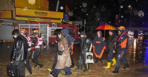 People walk through floodwater after torrential rain, Istanbul, Türkiye, Oct. 14, 2026. (AA Photo)