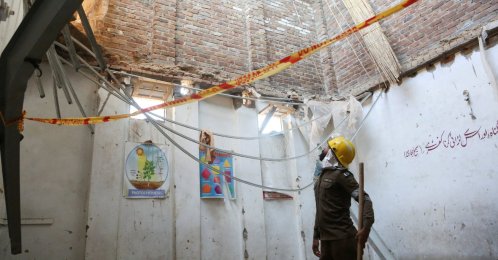 A rescue staff stands in a classroom after a school roof collapse in Peshawar, Pakistan, Oct. 15, 2026. (Reuters Photo)