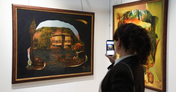 A visitor takes a photo of a painting at the “Legacy of the Past: From Traces to Horizons” exhibition at the Palace Collections Museum in Dolmabahçe Palace, Istanbul, Türkiye, Oct. 14, 2026. (AA Photo)