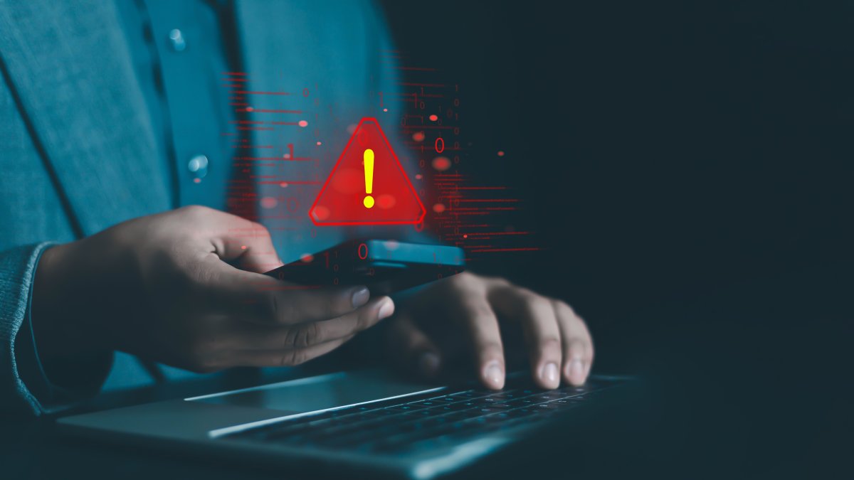 An illustration showing a system hacked warning alert on a laptop/phone. (Shutterstock Photo)