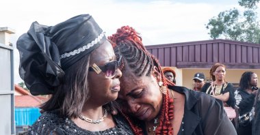 Mbatiabuh Regina Ngakum, sister of murdered woman Achiah Geraldine, is comforted as she grieves outside a mortuary chapel, Yaounde, Cameroon, Sept. 18, 2026. (AP Photo)