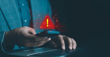 An illustration showing a system hacked warning alert on a laptop/phone. (Shutterstock Photo)