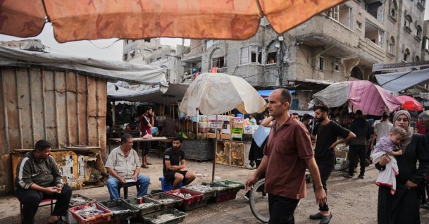 Palestinians walk through a market in the Al-Shati refugee camp, Gaza City, Palestine, Oct. 14, 2026. (AP Photo)
