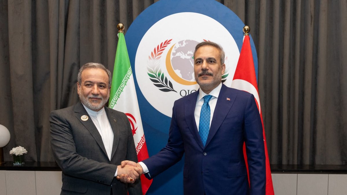 Foreign Minister Hakan Fidan shakes hands with Iranian Foreign Minister Abbas Araghchi on the sidelines of the 52nd Session of the Council of Foreign Ministers (CFM) of the Organisation of Islamic Cooperation (OIC) in Baghdad. (Photo by Turkish Foreign Ministry Press Service via AFP)