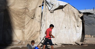 Children of displaced Palestinians play outside their temporary tent, Gaza City, Palestine, Oct. 7, 2026. (AFP Photo)