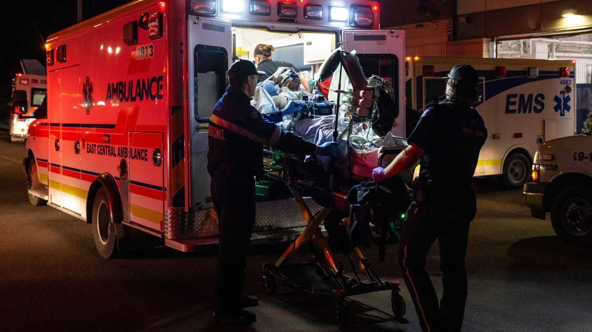 Paramedics load an injured person into an ambulance at the Wainwright Health Centre as injured military members are treated after a fire at Canadian Forces Base Wainwright, Alberta, Canada, Oct. 17, 2026. (AP Photo)