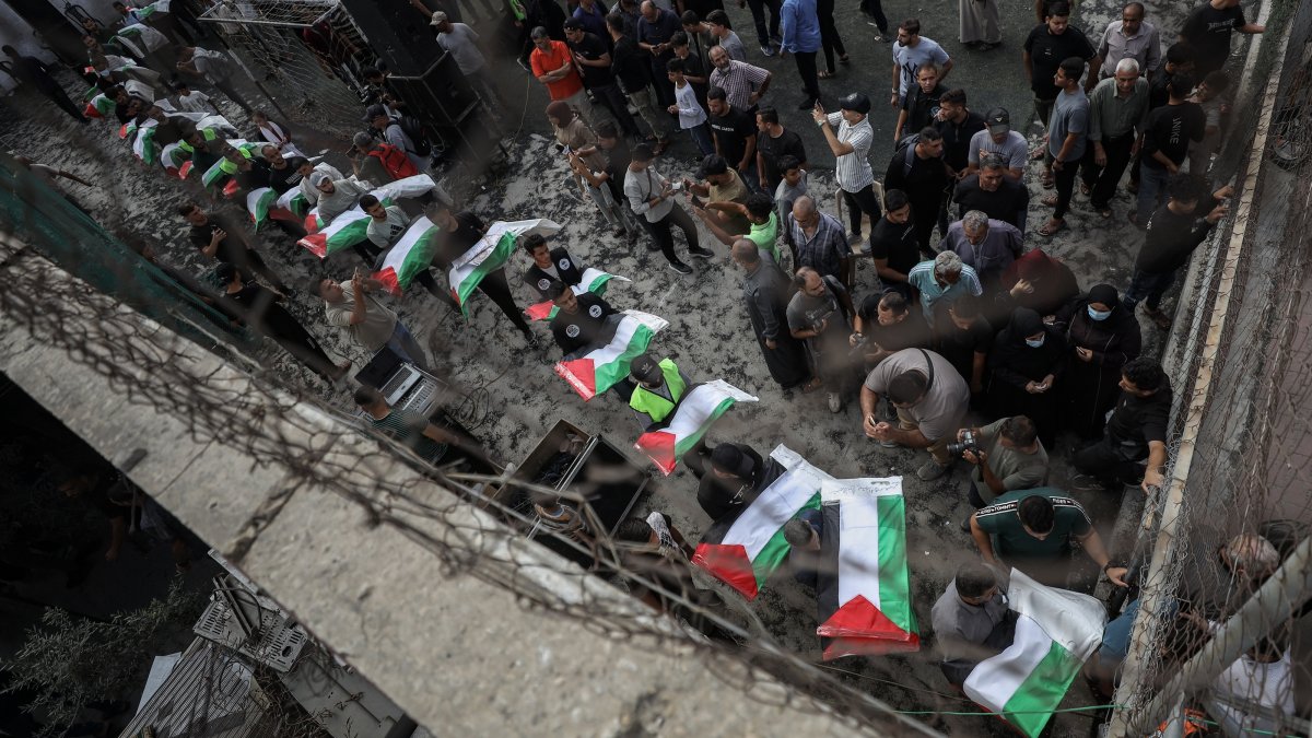 People carry the remains of Palestinians, who died under the rubble of a building destroyed in Israeli war on Gaza, for a funeral, Oct. 18, 2026. (AA Photo)