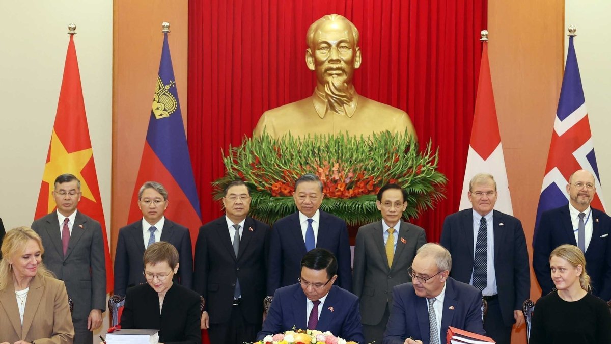 Switzerland's President Guy Parmelin, seated second right, and Vietnamese President To Lam, standing center, watch the signing of the Vietnam-EFTA Free Trade Agreement in Hanoi, Vietnam, Oct. 18, 2026. (AP Photo)