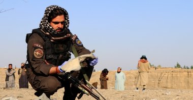 A member of the Taliban security forces inspects metal debris at the site of a partially damaged house following what Taliban officials say was a Pakistani airstrike in Gurbuz district, Khost province, Afghanistan, Sept. 24, 2026. (Reuters Photo)