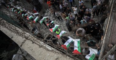 People carry the remains of Palestinians, who died under the rubble of a building destroyed in Israeli war on Gaza, for a funeral, Oct. 18, 2026. (AA Photo)