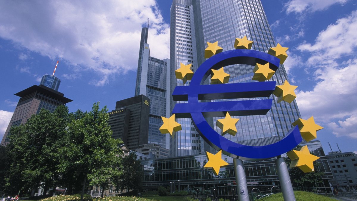 A sculpture of the Euro sign in front of financial district skyscrapers, Frankfurt, Germany, Sept. 3, 2005. (Getty Images Photo)
