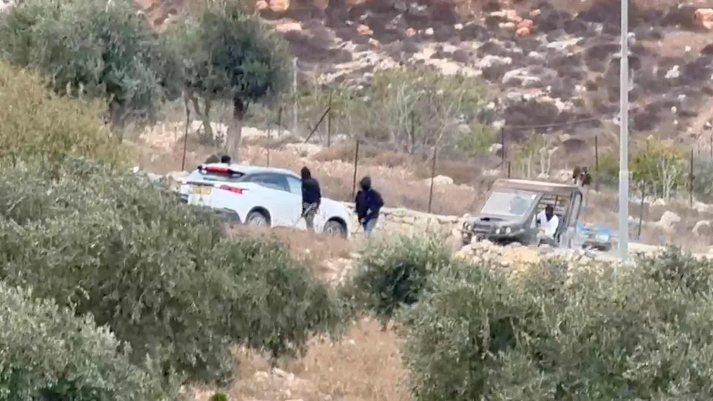 This screengrab shows vehicles at the site where masked terrorist settlers attacked Palestinians, Catholic representatives as well as Western diplomats and officials in Taybeh, in the Israeli-occupied West Bank, Oct. 17, 2026. (Reuters Photo)