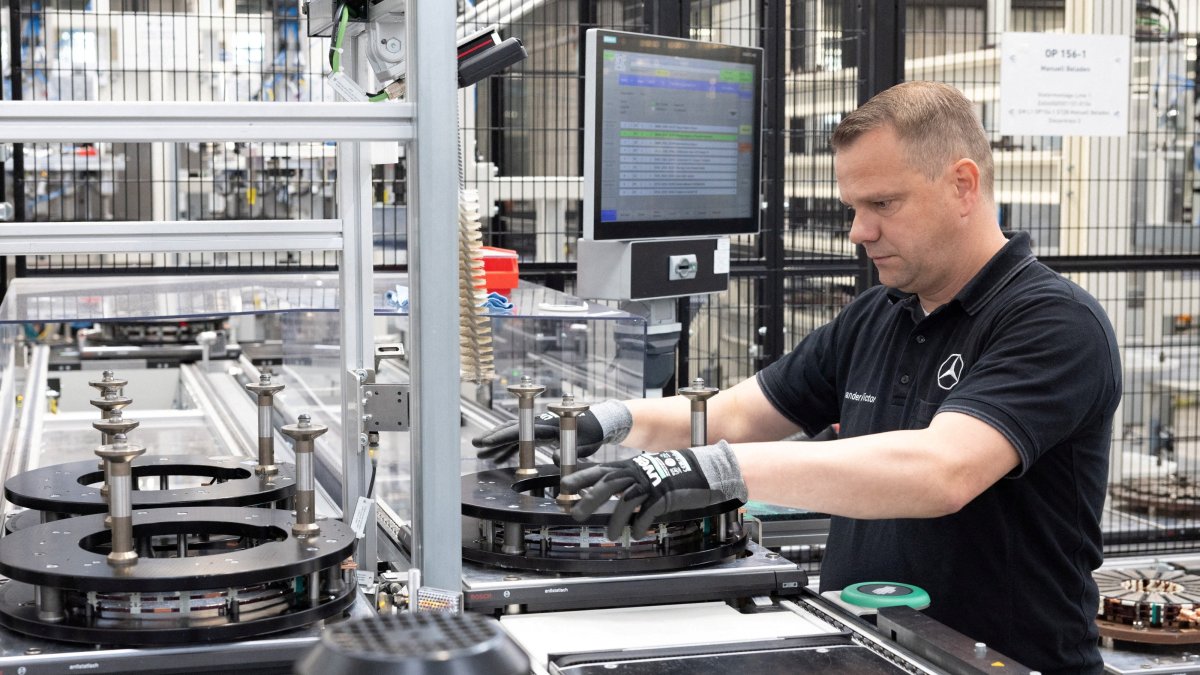 A worker assembles axial-flux motors for electric vehicles on an assembly line at the Mercedes-Benz engine factory, Berlin, Germany, June 9, 2026. (Reuters Photo)