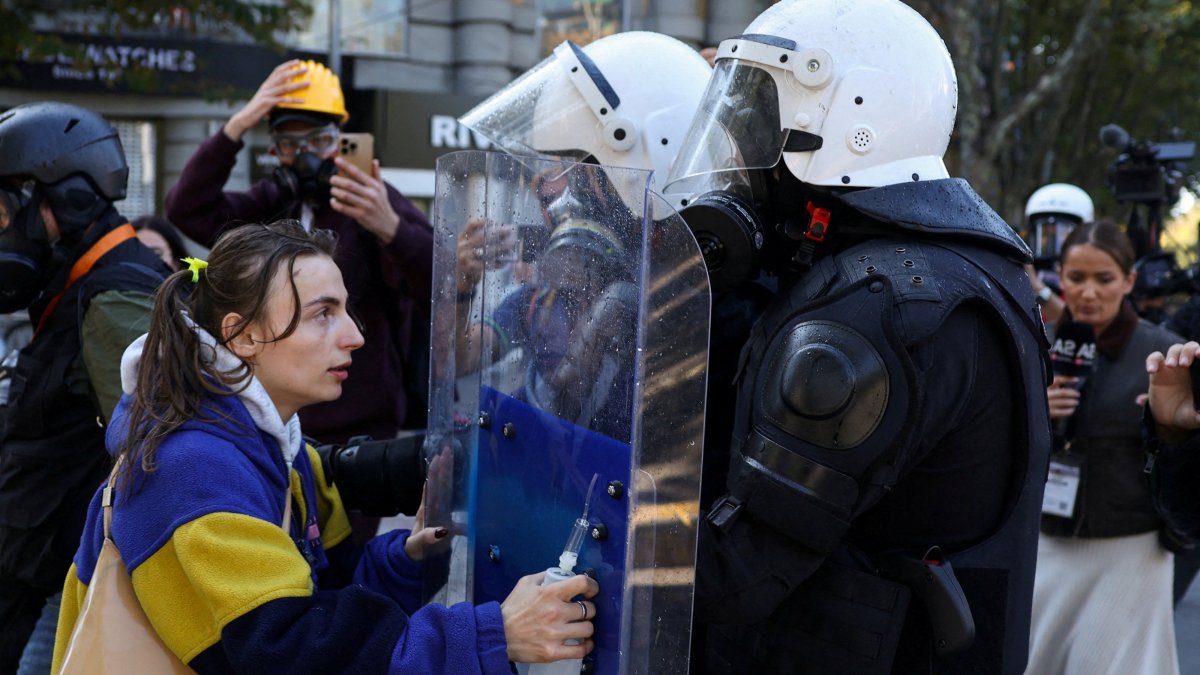 A demonstrator puts her hands on a police officer's riot shield, as Albanian students hold an anti-government protest in Tirana, Albania, Oct. 19, 2026. (Reuters Photo)