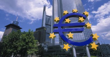 A sculpture of the Euro sign in front of financial district skyscrapers, Frankfurt, Germany, Sept. 3, 2005. (Getty Images Photo)
