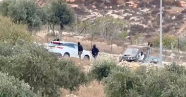 This screengrab shows vehicles at the site where masked terrorist settlers attacked Palestinians, Catholic representatives as well as Western diplomats and officials in Taybeh, in the Israeli-occupied West Bank, Oct. 17, 2026. (Reuters Photo)