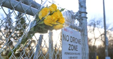 A bouquet of flowers sits on the fence by the main entrance to the military base in Wainwright, Alberta, Canada, Oct. 18, 2026. (EPA Photo)