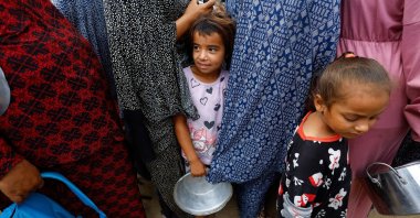 Palestinians wait to receive food from a soup kitchen funded by the WFP, in Deir al-Balah, in the central Gaza Strip, Palestine, Oct. 18, 2026. (Reuters Photo)