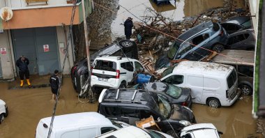 Car owners search for their vehicles swept away by the flood after heavy rain in the Ayazağa district, Istanbul, Türkiye, Oct. 15, 2026. (AFP Photo)