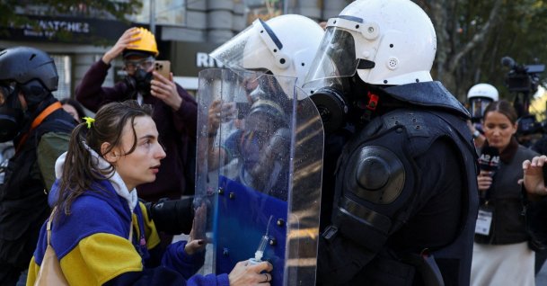 A demonstrator puts her hands on a police officer's riot shield, as Albanian students hold an anti-government protest in Tirana, Albania, Oct. 19, 2026. (Reuters Photo)