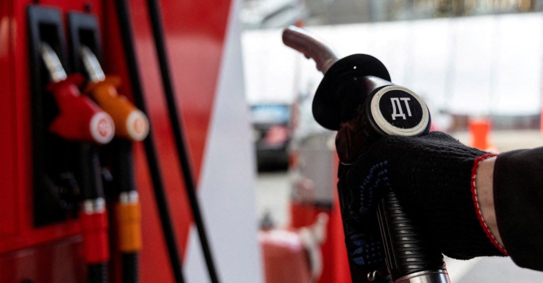 An employee holds a diesel fuel pump nozzle at a Neftmagistral petrol station, Moscow, Russia, Sept. 8, 2023. (Reuters Photo)
