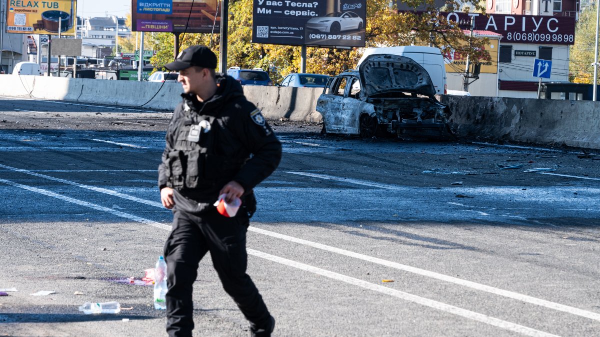 A police officer walks on a highway after a Russian strike on Chabany, near Kyiv, Ukraine, Oct. 20, 2026. (AP Photo)