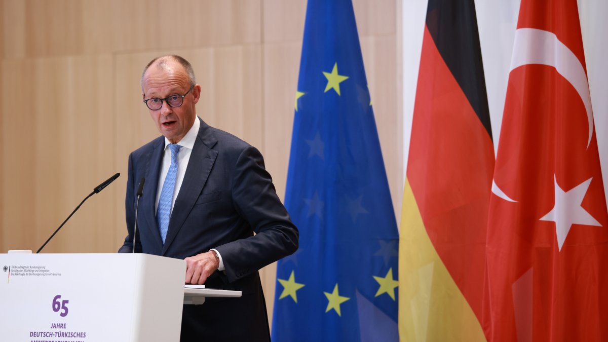 German Chancellor Friedrich Merz delivers a speech during a ceremony marking the 65th anniversary of the German-Turkish recruitment agreement in Berlin, Germany, Oct. 20, 2026.  (EPA Photo)