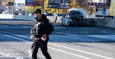 A police officer walks on a highway after a Russian strike on Chabany, near Kyiv, Ukraine, Oct. 20, 2026. (AP Photo)
