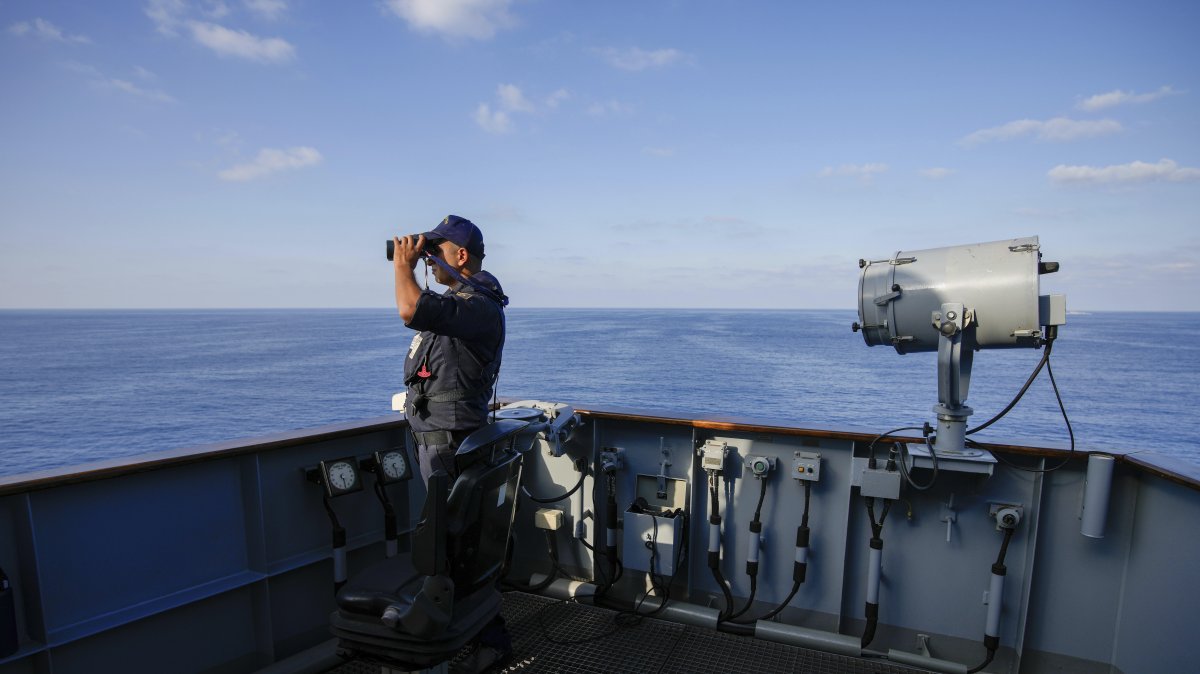 A Turkish naval officer uses binoculars to observe from aboard one of two military ships sailing in the Mediterranean Sea, Oct. 9, 2024. (AP Photo) 