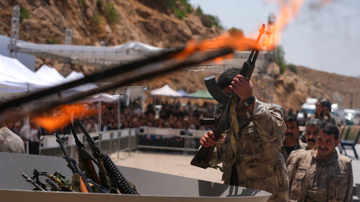 A PKK terrorist puts his weapon into a pit during the disarmament ceremony in the city of Sulaymaniyah, Iraq, July 11, 2025. (AA File Photo)