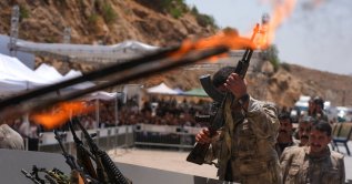 A PKK terrorist puts his weapon into a pit during the disarmament ceremony in the city of Sulaymaniyah, Iraq, July 11, 2025. (AA File Photo)