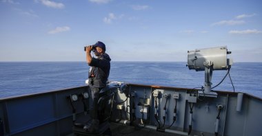 A Turkish naval officer uses binoculars to observe from aboard one of two military ships sailing in the Mediterranean Sea, Oct. 9, 2024. (AP Photo) 