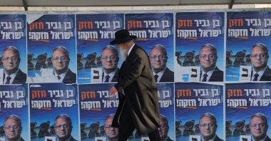 An Ultra-Orthodox man walks past an election billboard for Minister of National Security and leader of the Otzma Yehudit party, Itamar Ben-Gvir, west Jerusalem, Israel, Oct. 21, 2026. (EPA Photo)